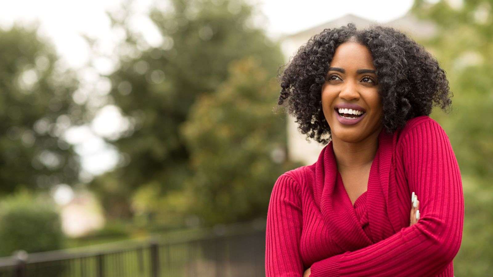 woman in red sweater laughing