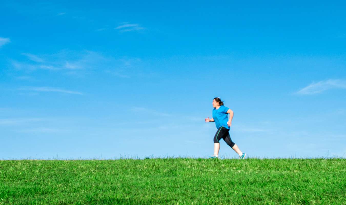 Woman in blue shirt running