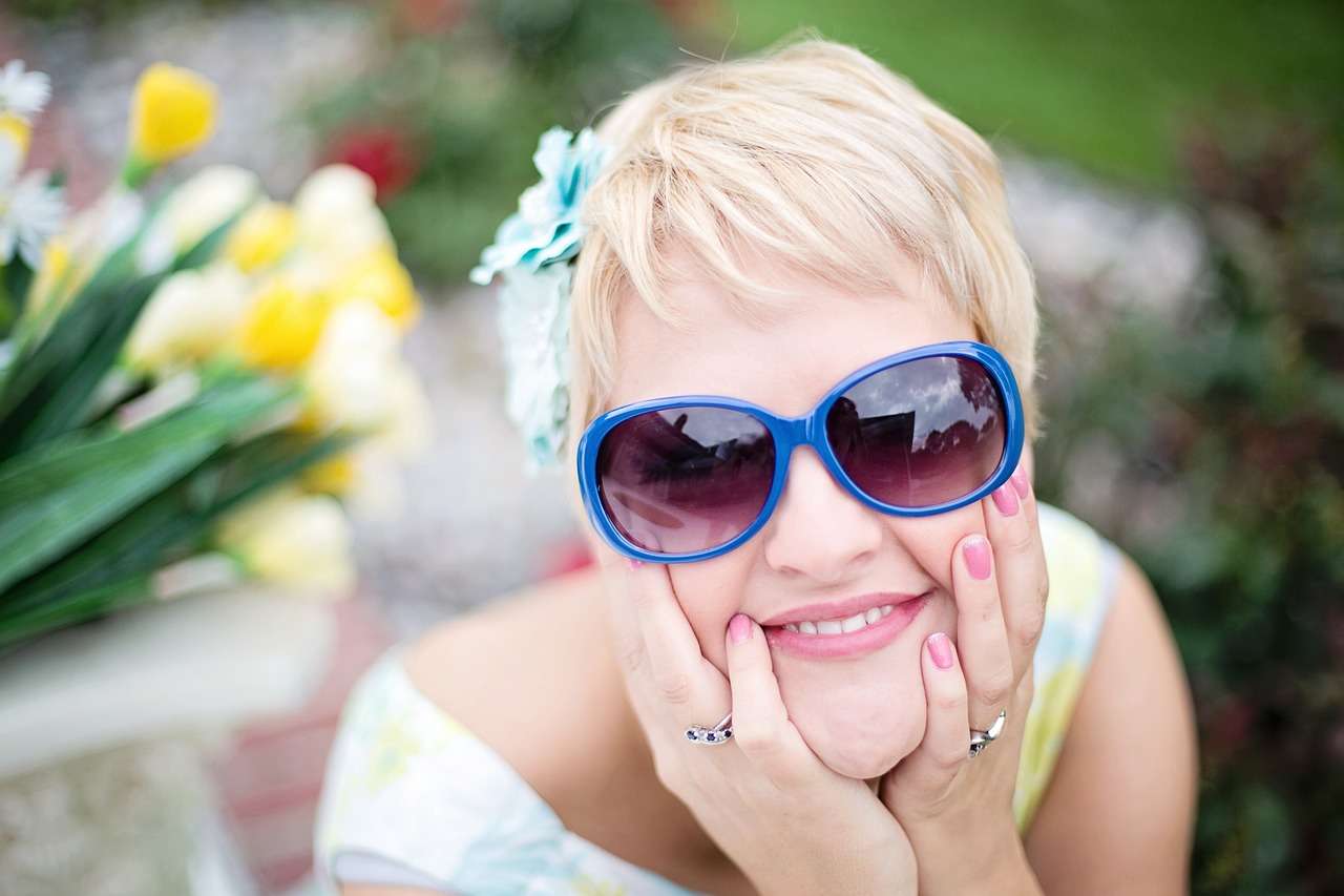 woman with blue sun glasses smiling at camera